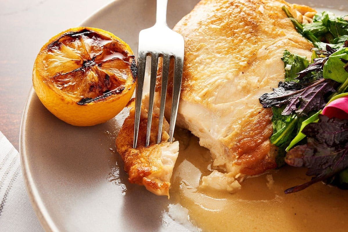 Roast chicken with charred lemon and greens