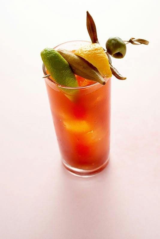 Bloody mary in a tall glass with a skewered garnish